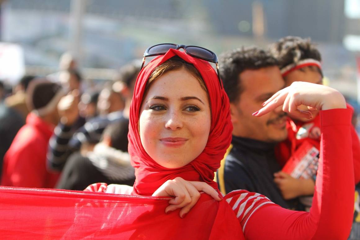 En ung kvinne smiler mens hun deltar i feiringen av at Hosni Mubaraks regime har falt. Foto: Israel Sun/REX/Scanpix